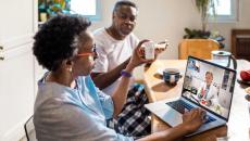 Married couple consult with their physician via telehealth