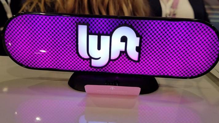 A Lyft logo sign on a table