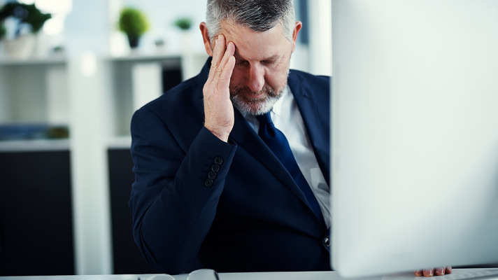 CIO experiences burnout, places hand to forehead